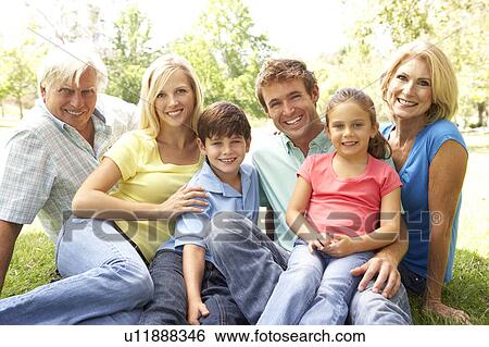Stock Photograph - Extended Group Portrait Of Family Enjoying Day In Park. Fotosearch
