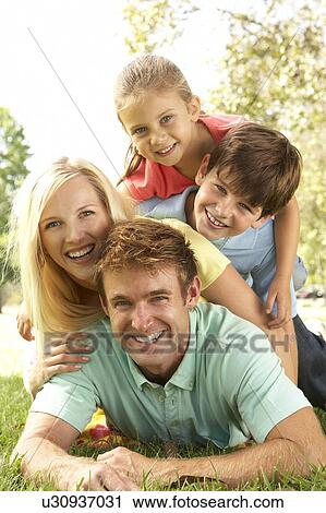 Stock Image - Family Group Having Fun In Park. Fotosearch