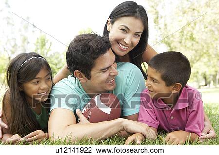 Stock Image - Family In Park With American Football. Fotosearch