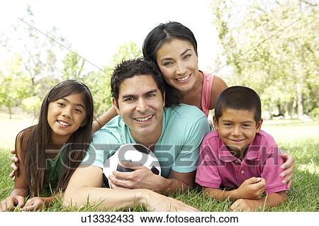 Stock Image - Family In Park With Football. Fotosearch