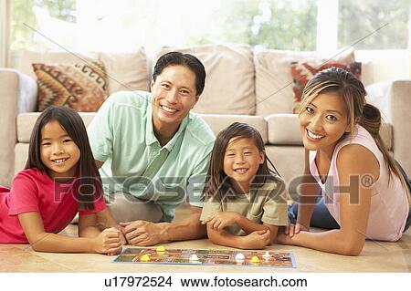 Picture - Family Playing Board Game At Home. Fotosearch