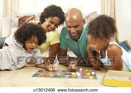 Stock Photograph - Family Playing Board Game At Home. Fotosearch