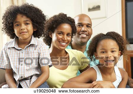 Stock Photo - Family Relaxing At Home On Sofa. Fotosearch