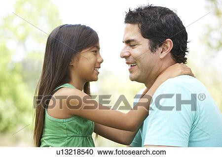 Stock Image - Father And Daughter In Park. Fotosearch