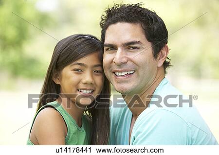Stock Image - Father And Daughter In Park. Fotosearch