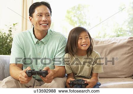 Father And Daughter Playing Computer Game At Home View Large Photo Image Stock Photo - Father And Daughter Playing Computer Game At Home. Fotosearch