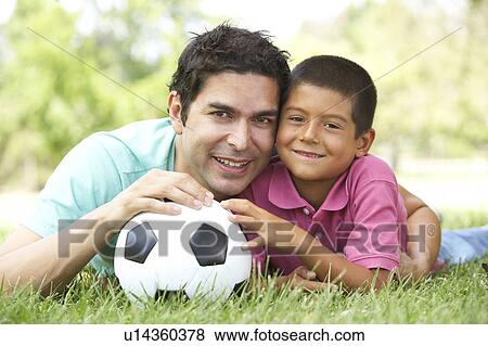 Stock Photo - Father And Son In Park With Football. Fotosearch