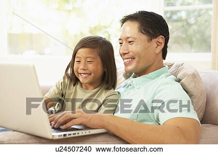 Father And Son Using Laptop At Home View Large Photo Image Stock Image - Father And Son Using Laptop At Home. Fotosearch