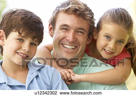 Stock Image - Father With Children In Park. Fotosearch
