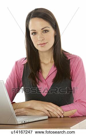 Female Businesswoman Using Laptop At Desk View Large Photo Image Stock Photo - Female Businesswoman Using Laptop At Desk. Fotosearch