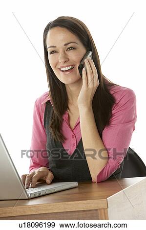 Stock Photo - Female Businesswoman Using Laptop At Desk. Fotosearch