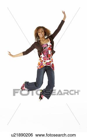 Stock Photograph - Full Length Studio Portrait Of Jumping Teenage Girl. Fotosearch