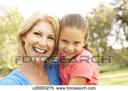 Stock Photography - Grandaughter Hugging Grandmother In Park. Fotosearch