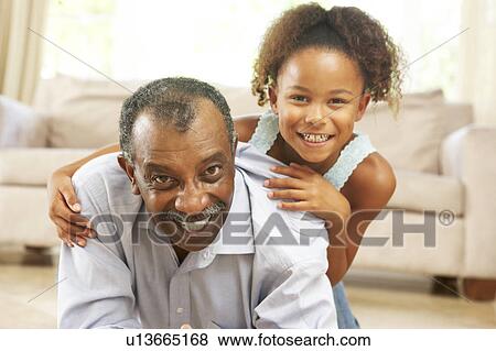 Grandfather And Granddaughter Playing Together At Home View Large Photo Image Stock Photo - Grandfather And Granddaughter Playing Together At Home. Fotosearch