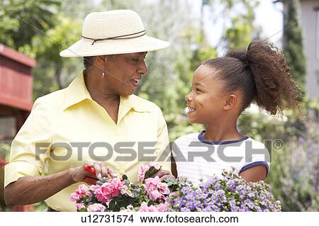 Grandmother With Granddaughter Gardening Together View Large Photo Image Picture - Grandmother With Granddaughter Gardening Together. Fotosearch