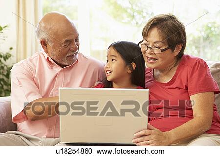 Grandparents And Grandaughter Using Laptop Computer At Home View Large Photo Image Stock Image - Grandparents And Grandaughter Using Laptop Computer At Home. Fotosearch