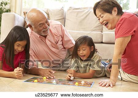 Grandparents And Grandchildren Playing Board Game At Home View Large Photo Image Stock Photo - Grandparents And Grandchildren Playing Board Game At Home. Fotosearch