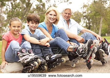 Stock Photo - Grandparents And Grandchildren Putting On In Line Skates In Park. Fotosearch