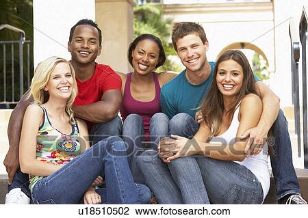 Stock Image - Group Of Friends Sitting On Steps Of Building. Fotosearch