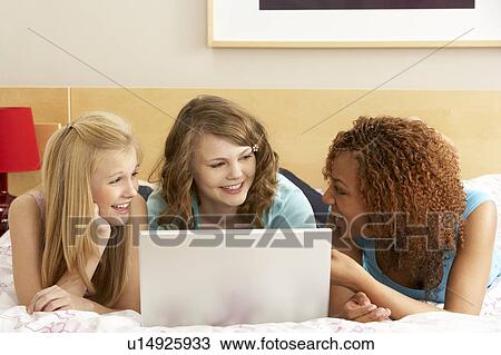 Group Of Three Teenage Girls Using Laptop In Bedroom View Large Photo Image Stock Image - Group Of Three Teenage Girls Using Laptop In Bedroom. Fotosearch
