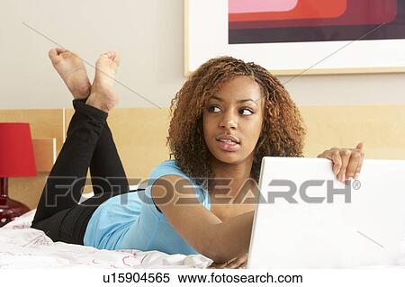 Guilty Teenage Girl Using Laptop In Bedroom View Large Photo Image Stock Photography - Guilty Teenage Girl Using Laptop In Bedroom. Fotosearch