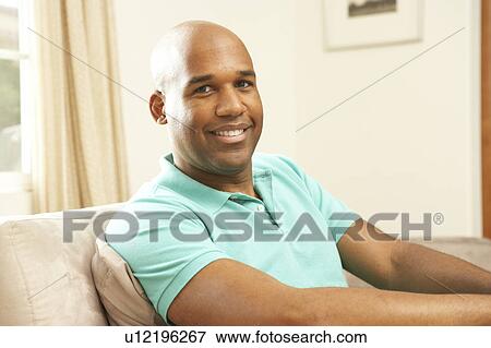 Man Relaxing On Sofa At Home View Large Photo Image Stock Photo - Man Relaxing On Sofa At Home. Fotosearch