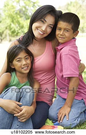 Stock Photography - Mother And Children In Park. Fotosearch