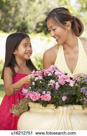 Mother And Daughter Gardening Together View Large Photo Image Stock Image - Mother And Daughter Gardening Together. Fotosearch