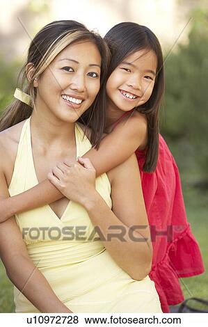 Mother And Daughter Hugging In Garden View Large Photo Image Stock Photo - Mother And Daughter Hugging In Garden. Fotosearch