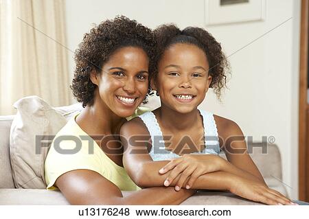 Mother And Daughter Relaxing On Sofa At Home View Large Photo Image Stock Photo - Mother And Daughter Relaxing On Sofa At Home. Fotosearch