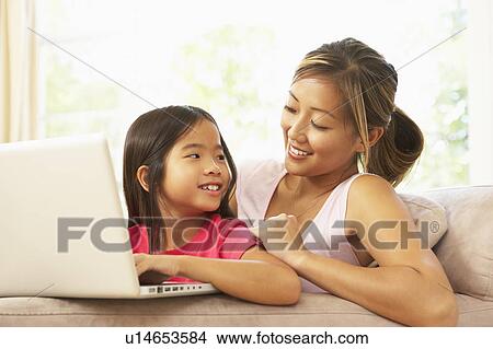 Mother And Daughter Using Laptop At Home View Large Photo Image Picture - Mother And Daughter Using Laptop At Home. Fotosearch