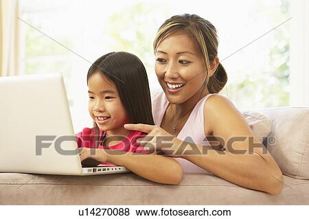Mother And Daughter Using Laptop At Home View Large Photo Image Stock Photo - Mother And Daughter Using Laptop At Home. Fotosearch