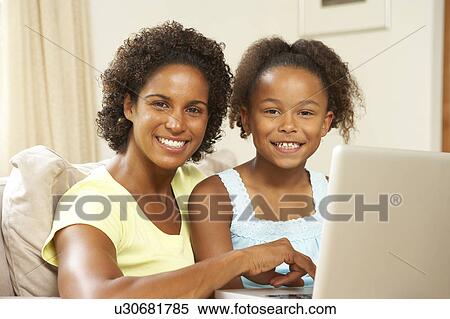 Mother And Daughter Using Laptop At Home View Large Photo Image Stock Photography - Mother And Daughter Using Laptop At Home. Fotosearch