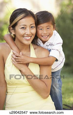 Mother And Son Hugging In Garden View Large Photo Image Stock Photo - Mother And Son Hugging In Garden. Fotosearch