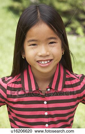 Stock Image - Portait Of Smiling Young Girl Outdoors. Fotosearch