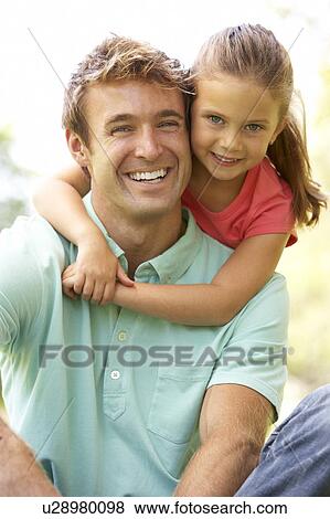 Stock Photo - Portrait Of Father And Daughter In Park. Fotosearch