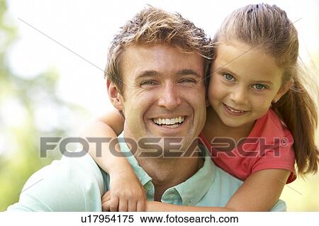 Stock Photography - Portrait Of Father And Daughter In Park. Fotosearch