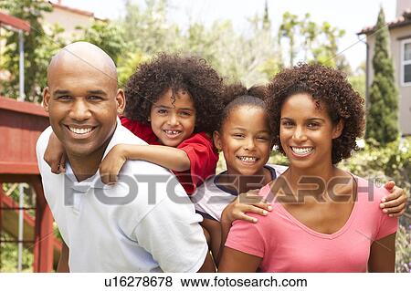 Stock Photo - Portrait of Happy Family In Garden. Fotosearch