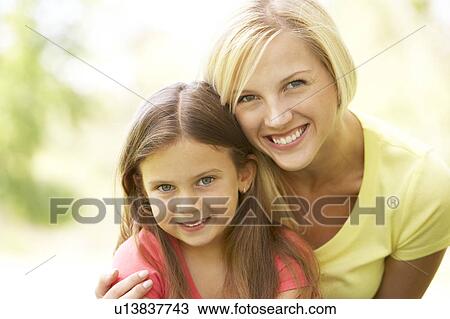Stock Image - Portrait Of Mother And Daughter In Park. Fotosearch