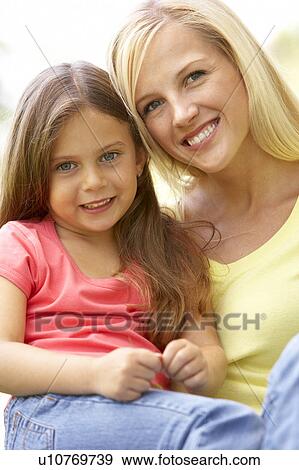Stock Photo - Portrait Of Mother And Daughter In Park. Fotosearch