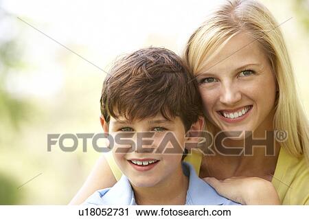 Stock Image - Portrait Of Mother And Son In Park. Fotosearch