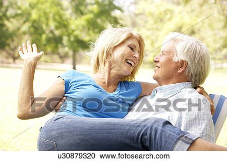 Stock Image - Portrait Of Senior Couple Enjoying Day In Park. Fotosearch
