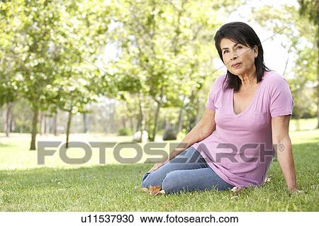 Stock Image - Portrait Of Senior Woman In Park. Fotosearch
