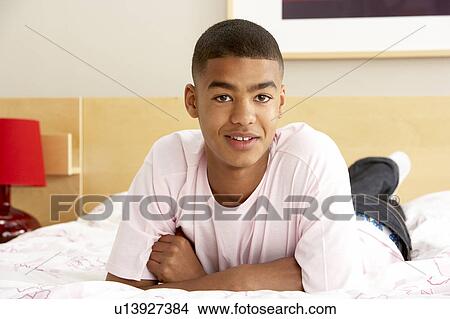 Picture - Portrait Of Teenage Boy In Bedroom. Fotosearch