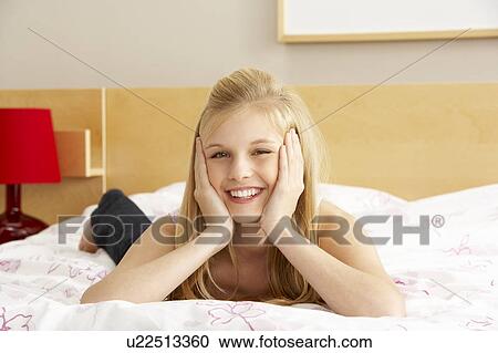 Stock Image - Portrait Of Teenage Girl In Bedroom. Fotosearch