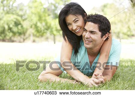 Stock Image - Portrait Of Young Couple In Park. Fotosearch