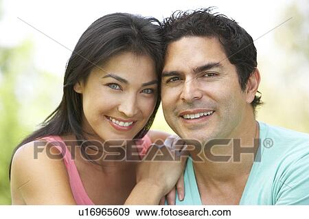 Stock Photo - Portrait Of Young Couple In Park. Fotosearch