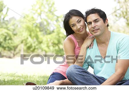 Stock Photo - Portrait Of Young Couple In Park. Fotosearch