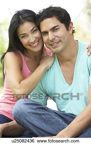 Stock Photograph - Portrait Of Young Couple In Park. Fotosearch