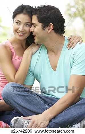 Stock Photograph - Portrait Of Young Couple In Park. Fotosearch